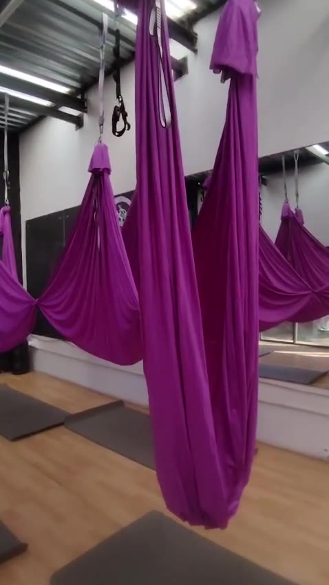 A row of aerial silks knotted and ready